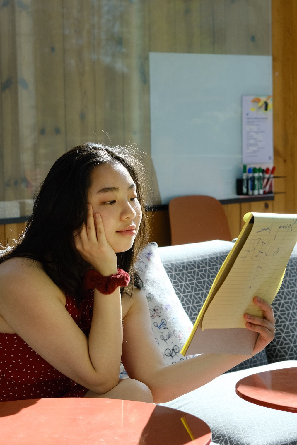 Portrait of Winnie Ma reading a notebook in warm afternoon light